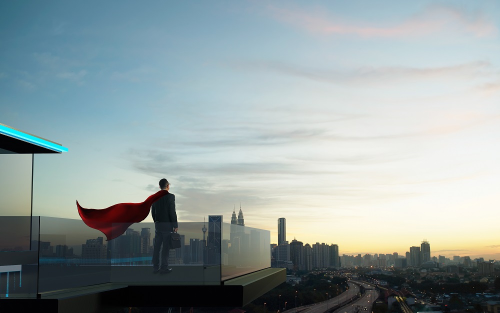 Businessman in suit and cape hero stand at open balcony looking great cityscape view and thinking business plan of the future